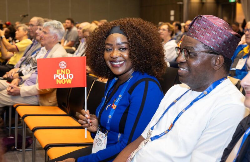 Rotary members with an End Polio Now flag